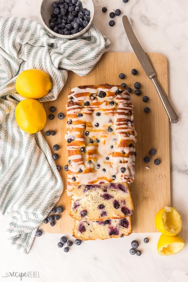 lemon blueberry bread sliced overhead with two slices and blue towel