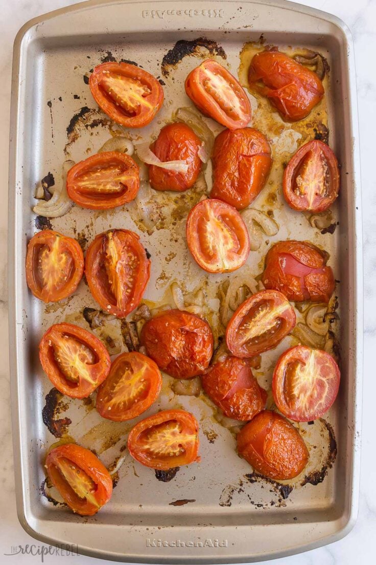 roasted tomatoes and onions on a baking sheet
