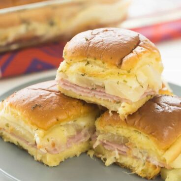 These Hawaiian Ham and Pineapple Sliders are an easy appetizer, lunch or dinner with just a few ingredients. Perfect for a potluck barbecue, game day or a fun weeknight meal! Includes step by step recipe video | easy recipe | game day | superbowl | football | party food | party ideas