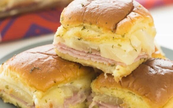 These Hawaiian Ham and Pineapple Sliders are an easy appetizer, lunch or dinner with just a few ingredients. Perfect for a potluck barbecue, game day or a fun weeknight meal! Includes step by step recipe video | easy recipe | game day | superbowl | football | party food | party ideas