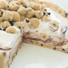 This Cookie Dough Ice Cream Cake is an easy, no bake dessert for a summer cookout or birthday party! Made on a cookie dough crust, filled with no churn ice cream and topped with chunks of cookie dough. Includes step by step recipe video | dessert recipe | cookie recipe | no bake dessert | summer | Easter | spring | birthday party