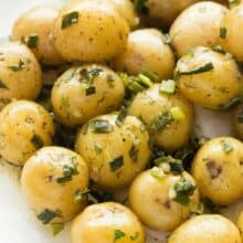 This no mayo Garlic Herb Potato Salad is great warm or cold -- the perfect make ahead side dish for summer barbecues, loaded with fresh herbs! Includes step by step recipe video.
