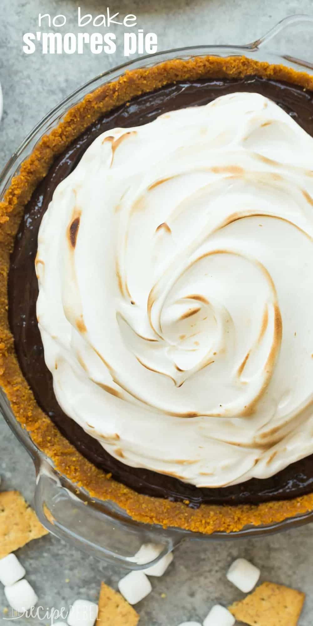 This No Bake S'mores Pie is an easy no bake dessert made with a chocolate pudding filling, no bake graham crust and loaded with homemade marshmallow cream! long overhead image of no bake smores pie with toasted marshmallow cream