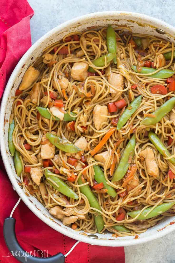 one pot chicken chow mein overhead on grey background with red towel on the side