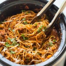 This Healthier Slow Cooker Spaghetti and Meat Sauce is loaded with veggies and protein but tastes just like your old favorite! It cooks completely in the slow cooker -- even the pasta! Includes step by step recipe video. | slow cooker recipe | crock pot recipe | crock pot dinner | ground beef recipe | healthy dinner | low calorie | high fiber