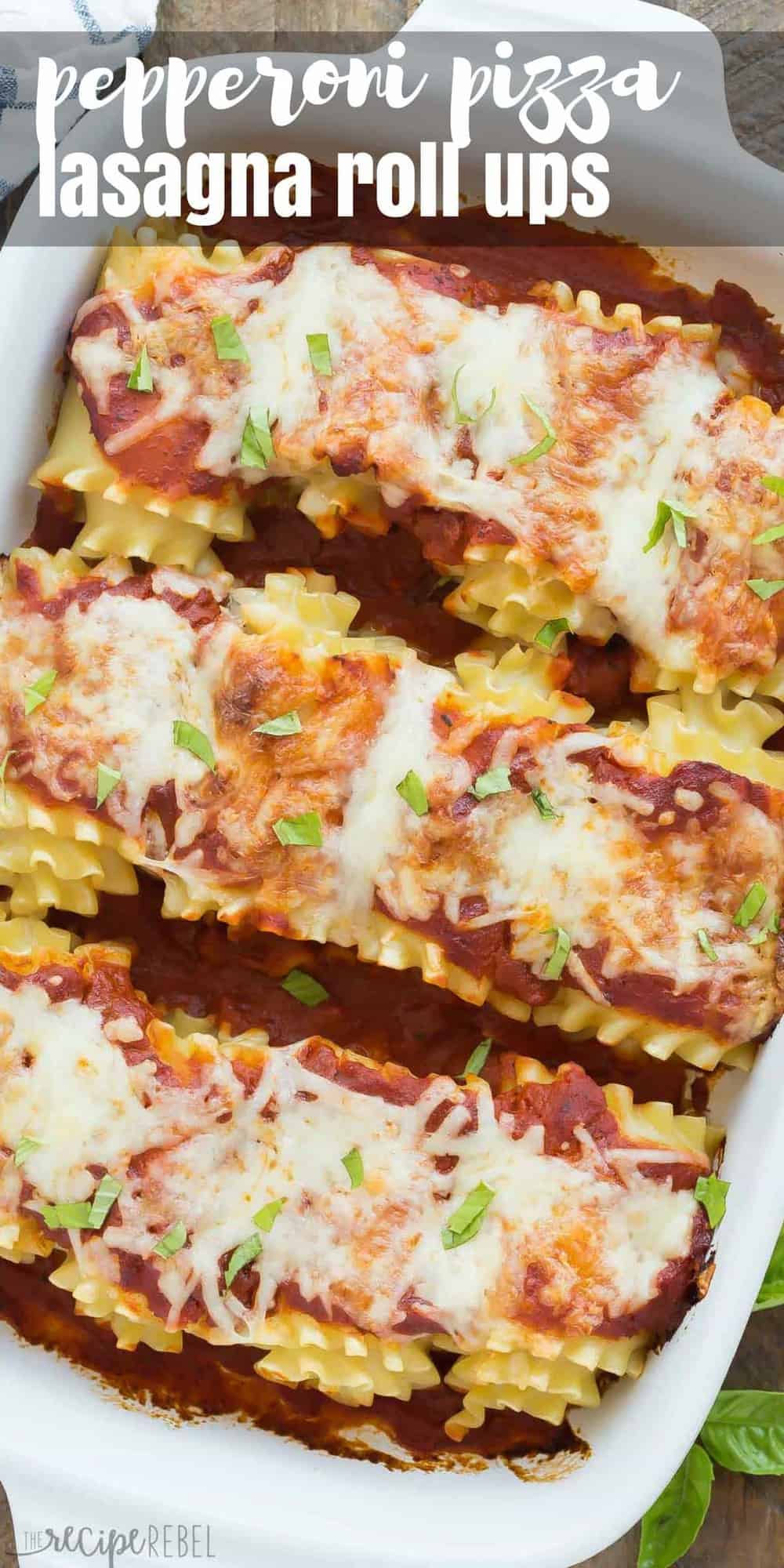 long overhead image of pepperoni pizza roll ups in white baking dish sprinkled with fresh parsley