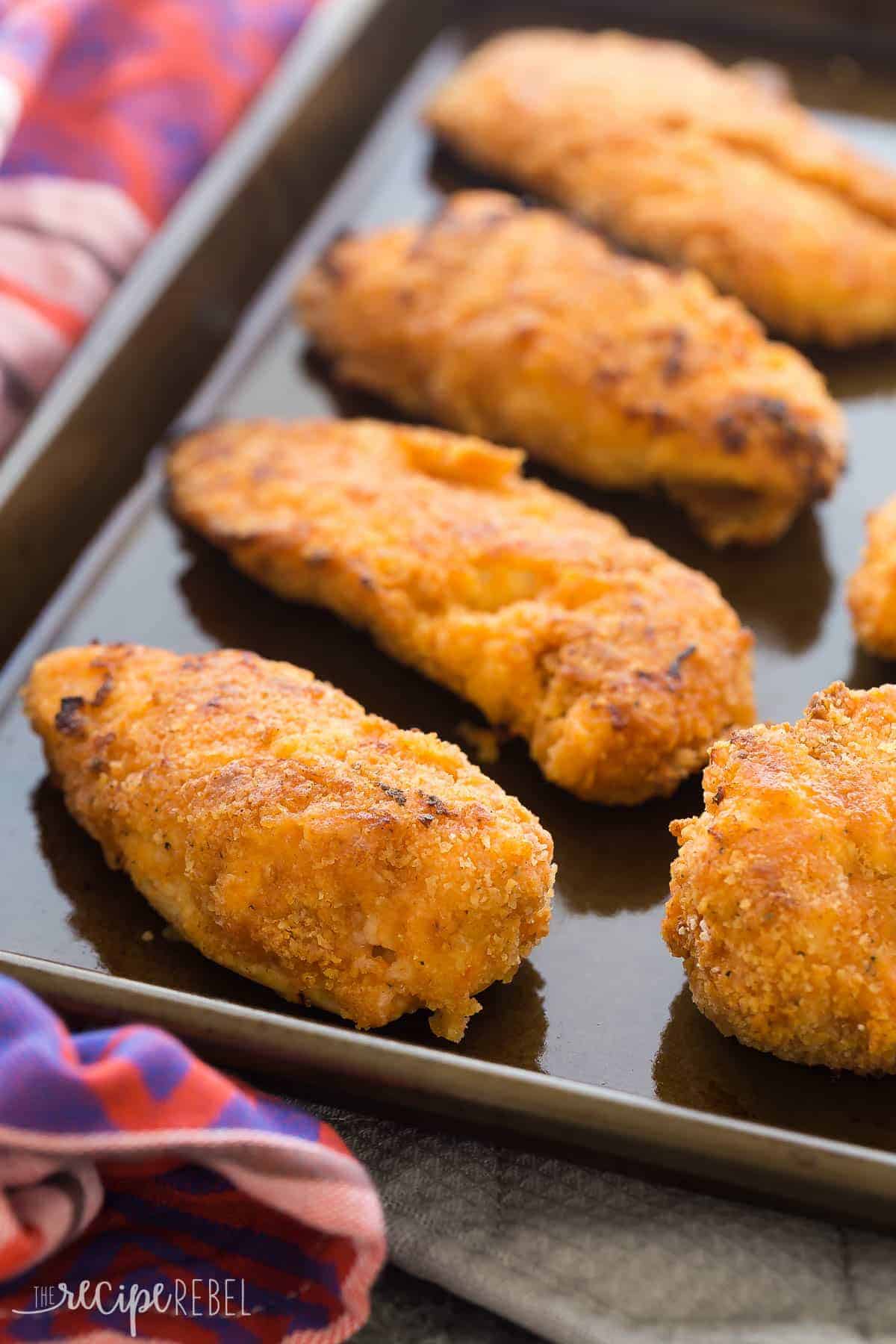 crispy sriracha buttermilk oven fried chicken pieces on dark sheet pan