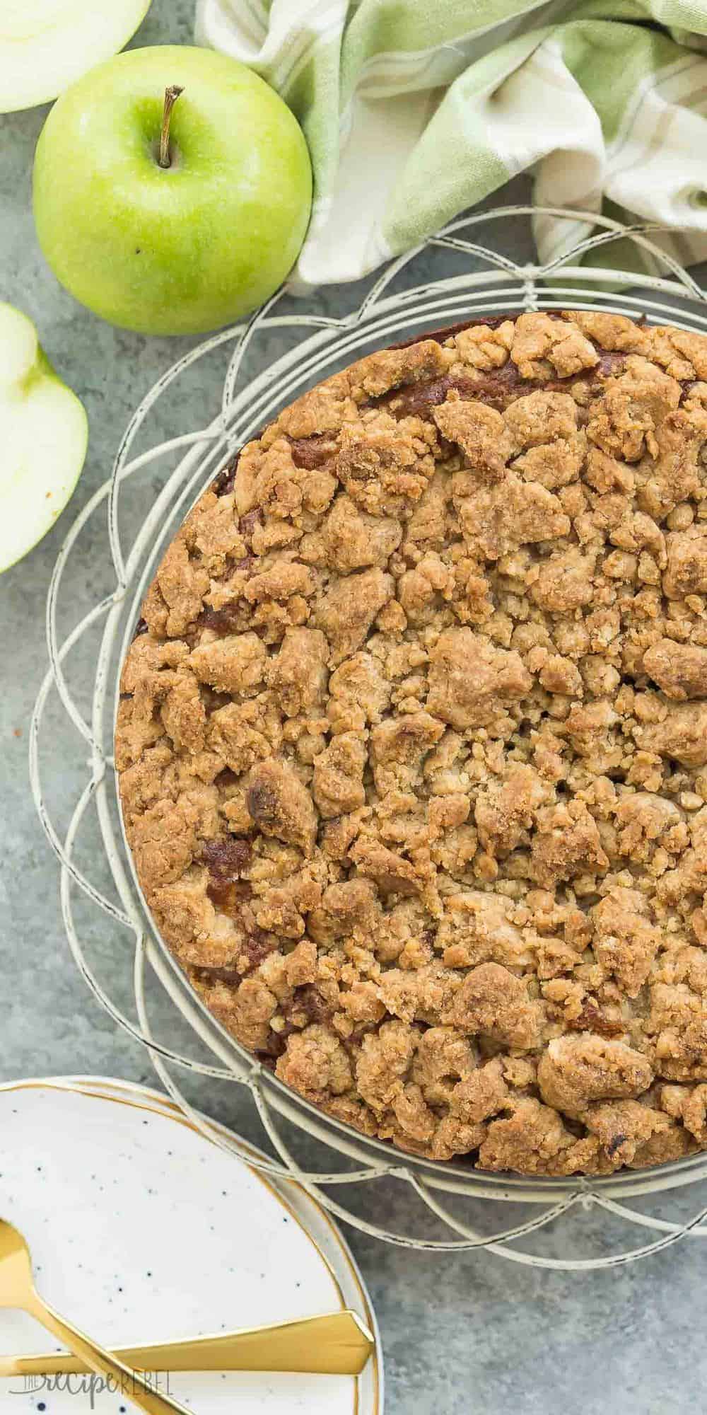 long image of apple coffee cake overhead on white cooling rack