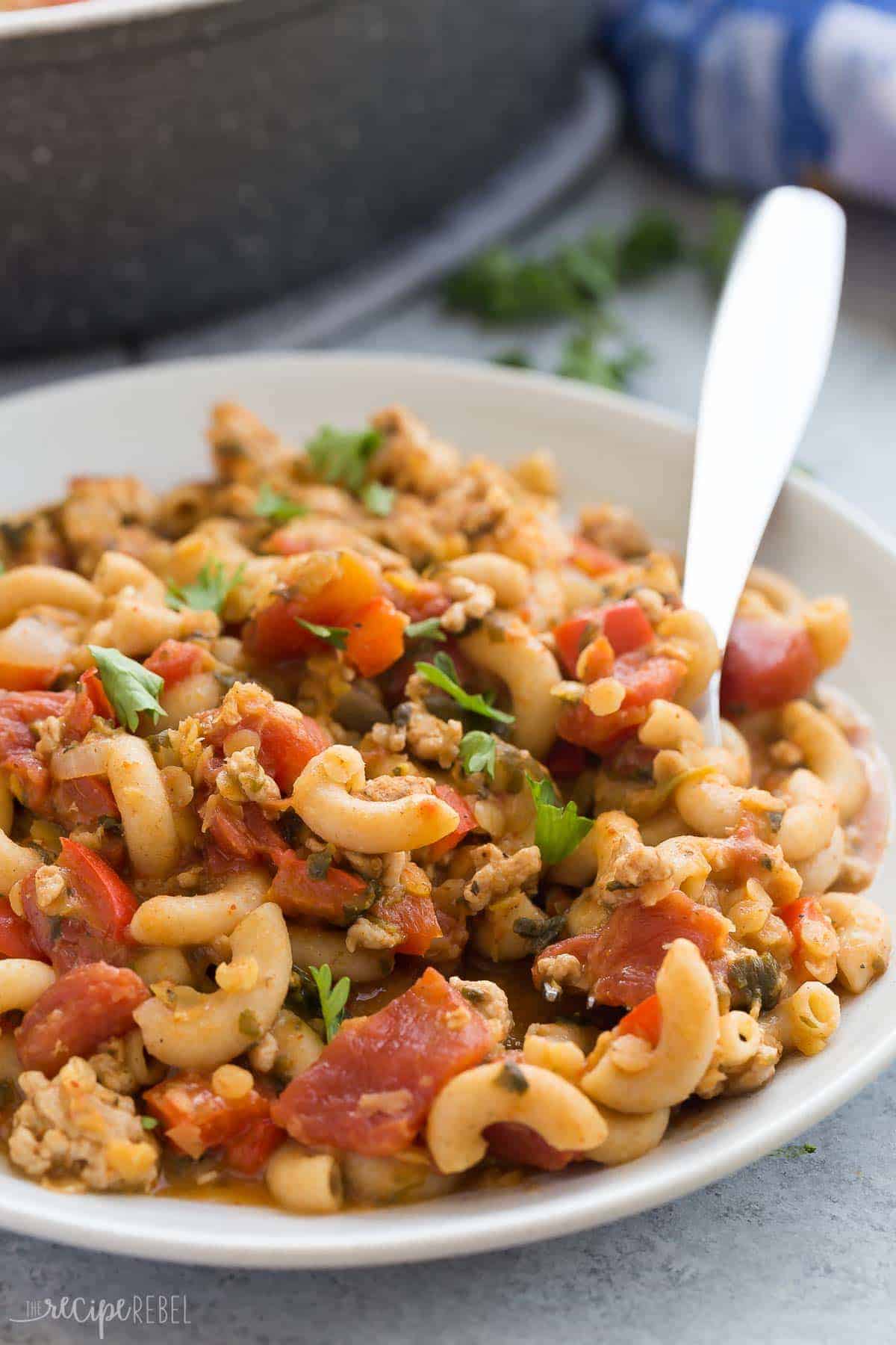 plate of turkey chili mac close up with fork stuck in pasta