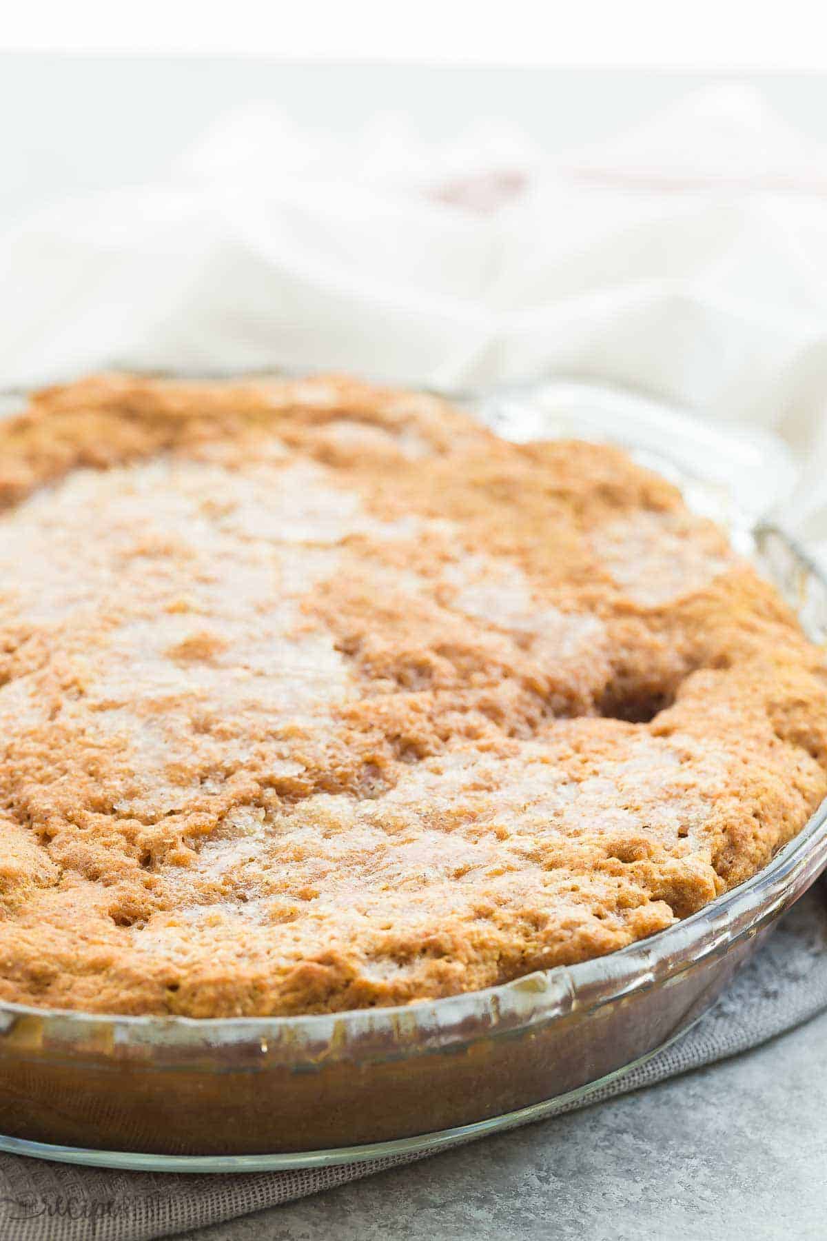 This Easy Pumpkin Pudding Cake takes just 10 minutes prep and makes it's own caramel pudding sauce as it bakes! Perfect hot from the oven with a scoop of ice cream. Includes step by step recipe video pumpkin pudding cake in glass pie plate whole