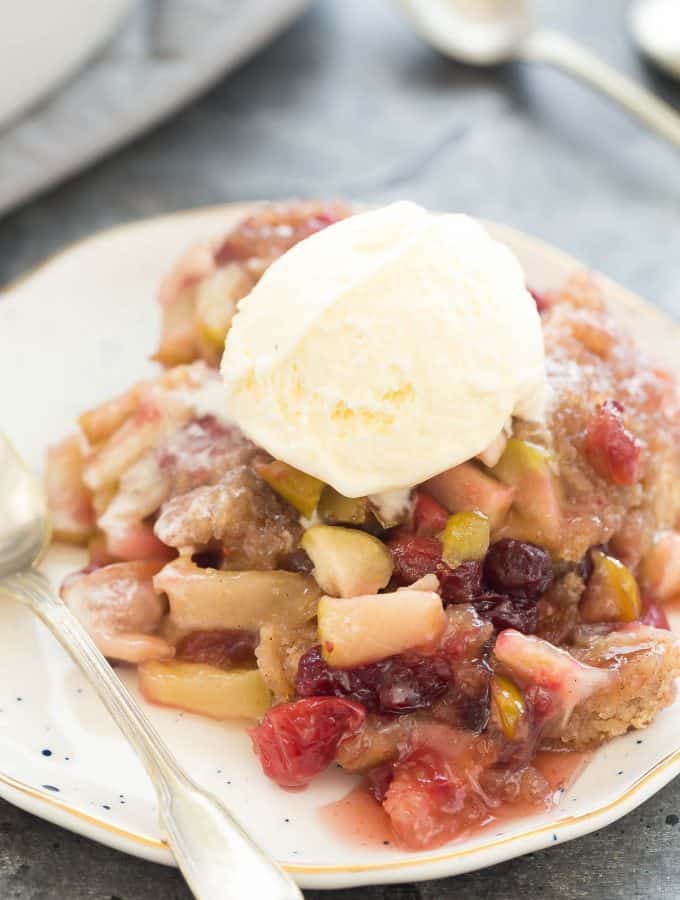 This Slow Cooker Cranberry Apple Cobbler is an easy dessert for fall or Thanksgiving! It makes its own gooey cranberry apple sauce as it cooks -- all you need is a scoop of ice cream! Includes step by step recipe video. | slow cooker recipe | slow cooker dessert | crock pot recipe | crock pot dessert | fall dessert | thanksgiving dessert