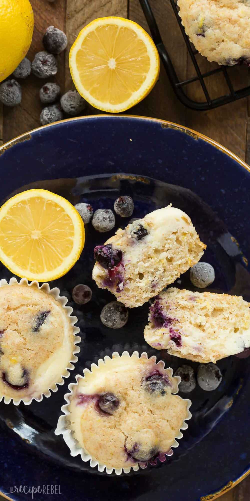 dark blue plate with lemon blueberry muffins and one cut in half