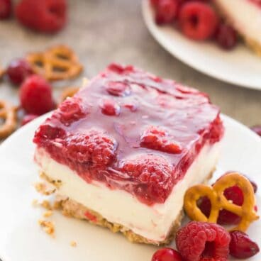 This Cranberry Raspberry Pretzel Salad Dessert is an easy holiday dessert salad that will be a big hit at Christmas or Thanksgiving! Made with cream cheese, fresh fruit and real fruit juice instead of Jello and includes a step by step recipe video. | christmas dessert recipe | holiday dessert | cranberry dessert | raspberry dessert | Thanksgiving recipe | no bake dessert