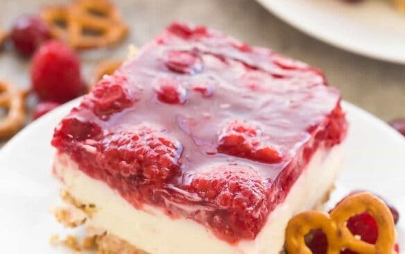 This Cranberry Raspberry Pretzel Salad Dessert is an easy holiday dessert salad that will be a big hit at Christmas or Thanksgiving! Made with cream cheese, fresh fruit and real fruit juice instead of Jello and includes a step by step recipe video. | christmas dessert recipe | holiday dessert | cranberry dessert | raspberry dessert | Thanksgiving recipe | no bake dessert
