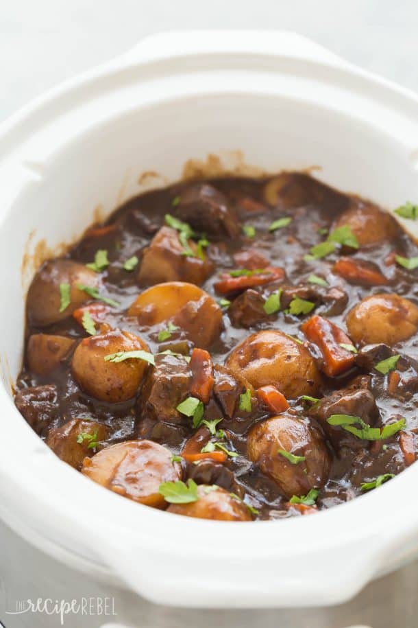 These EASY Crockpot Meals are perfect for those busy weekdays when it's a struggle to get dinner on the table, cozy and comforting for cooler days, or light and fresh for summer days. There's something for everyone! Crockpot pasta, soups, tacos, slow cooker ribs, pork, chicken or beef. TONS of easy crockpot dinners. #crockpot #slowcooker #easyrecipe #recipe #recipes #dinner #cooking slow cooker honey balsamic beef stew in white crockpot sprinkled with fresh parsley