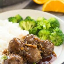 These Easy Meatballs in Orange Sauce have just a few ingredients and are perfect for a quick dinner, freezer meal, or even a holiday dinner or appetizer! Perfect over rice or with mashed potatoes. Includes step by step recipe video. | homemade meatball recipe | takeout | easy dinner recipe | weeknight meal | freezer meal