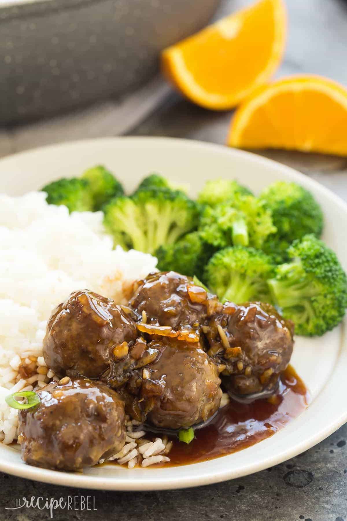 grey plate with meatballs and orange sauce over rice with broccoli