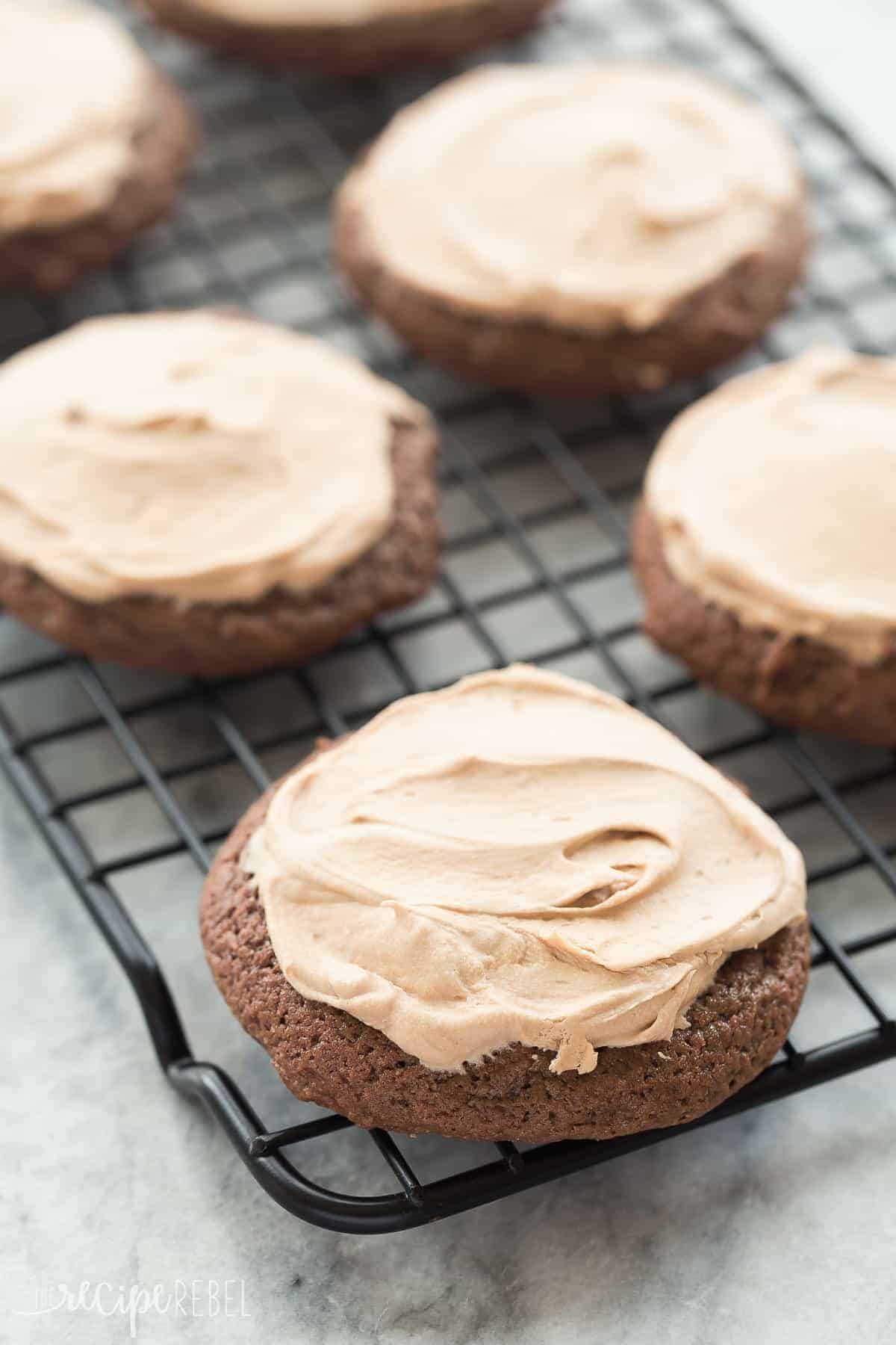 close up image of chocolate sour cream cookies with frosting