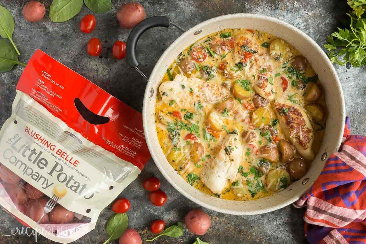 This One Pan Tuscan Chicken and Potato Skillet is an easy dinner idea that is loaded with flavor! With tomatoes, spinach, potatoes and a light Parmesan cream sauce, it's perfect one pot comfort food. Includes step by step recipe video. | chicken dinner | healthy dinner idea | one pot meal | one pan meal | italian chicken | gluten-free