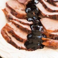 This Slow Cooker Balsamic Cherry Glazed Ham couldn't be easier -- the slow cooker keeps the meat so juicy and the Balsamic Cherry Glaze adds so much sweet and tangy flavor! It's perfect for Easter, Christmas or Thanksgiving. Includes step by step recipe video. | slow cooker recipe | crockpot | crock pot | holiday | sauce | cherry sauce | glaze for ham