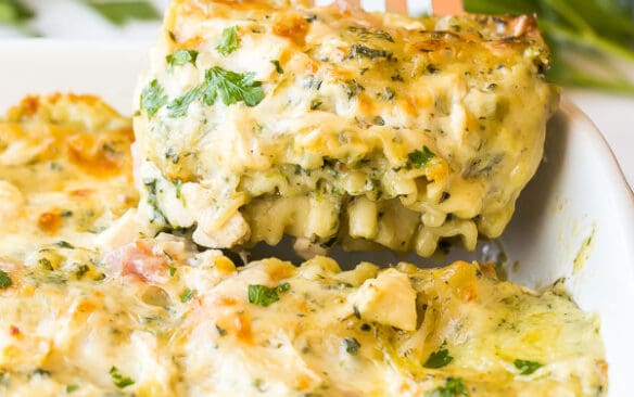 Piece of white lasagna being lifted out of pan