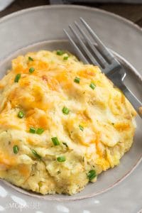 These Cheesy Make Ahead Mashed Potatoes are so creamy and perfect for the holidays! No more rushing around before Christmas dinner -- simply reheat and serve! Includes step by step recipe video. | make ahead meal | meal prep | cheesy mashed potatoes | cream cheese mashed potatoes | Christmas | Thanksgiving | Easter | holiday dinner