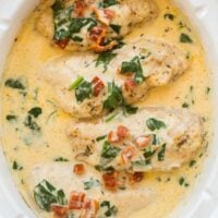 overhead image of crockpot tuscan chicken in white slow cooker