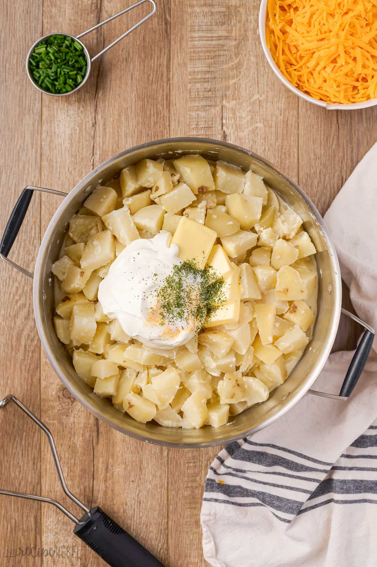 mashing potatoes with sour cream butter and seasoning