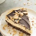 This No Bake Nanaimo Bar Cheesecake has all of the familiar flavors of the classic Nanaimo bar but in an easy no bake cheesecake! The perfect Christmas dessert (but I won't tell if you indulge year round!). Includes step by step recipe video. | no bake cheesecake | no bake dessert | chocolate | almonds | coconut