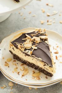 This No Bake Nanaimo Bar Cheesecake has all of the familiar flavors of the classic Nanaimo bar but in an easy no bake cheesecake! The perfect Christmas dessert (but I won't tell if you indulge year round!). Includes step by step recipe video. | no bake cheesecake | no bake dessert | chocolate | almonds | coconut