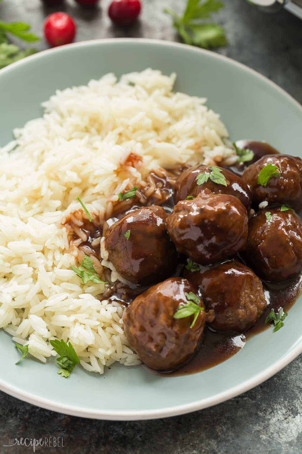 slow cooker cranberry meatballs on blue plate with white rice 