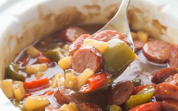 These Sweet & Sour Slow Cooker Smokies are an easy holiday appetizer or weeknight meal! Just a few minutes prep and let them cook away in the crockpot. Includes step by step recipe video. | slow cooker appetizer | slow cooker recipe | crock pot appetizer | holiday dish | game day | superbowl | potluck recipe | easy recipe