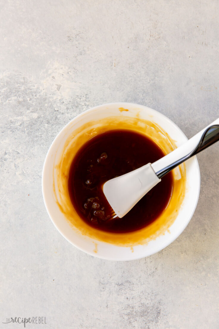 stirring together apricot sauce for sheet pan dinner