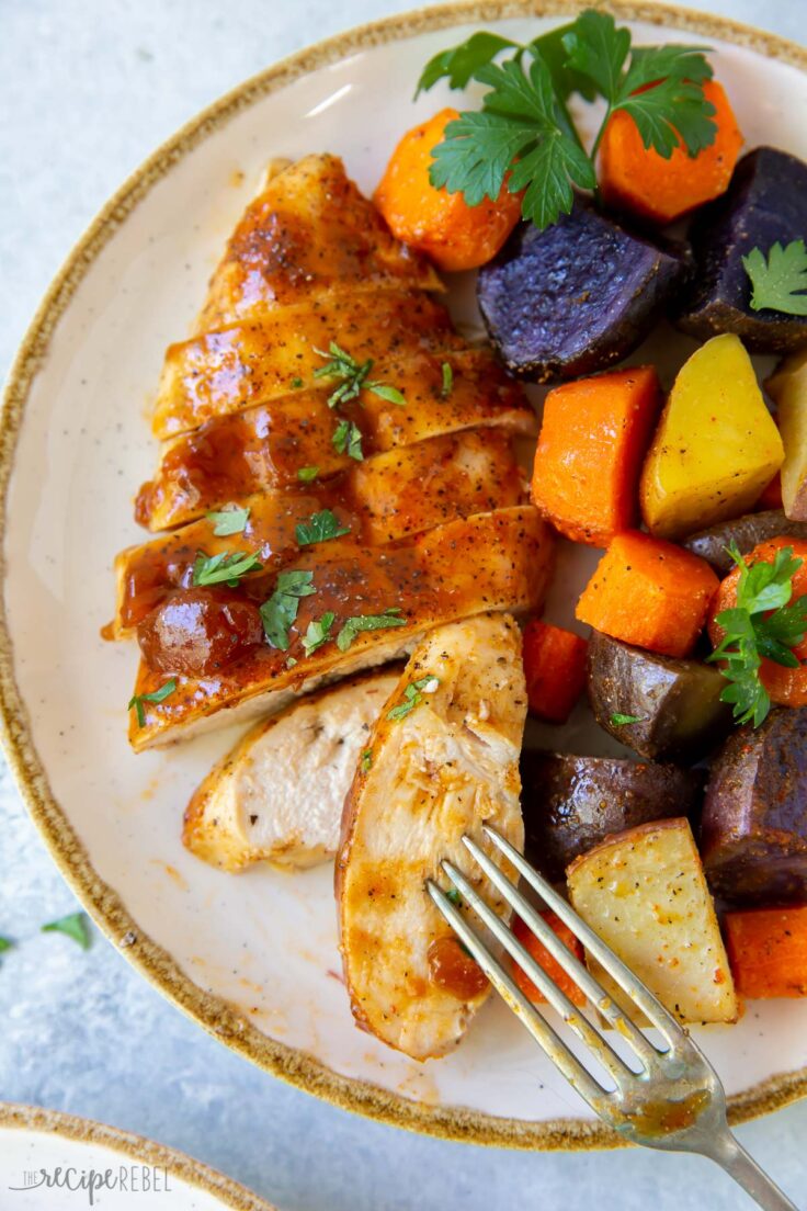 close up image of apricot chicken sheet pan dinner on white plate