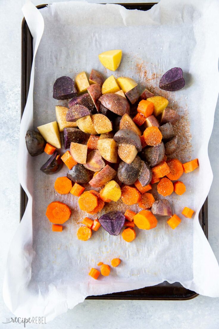 seasonings vegetables on a lined sheet pan