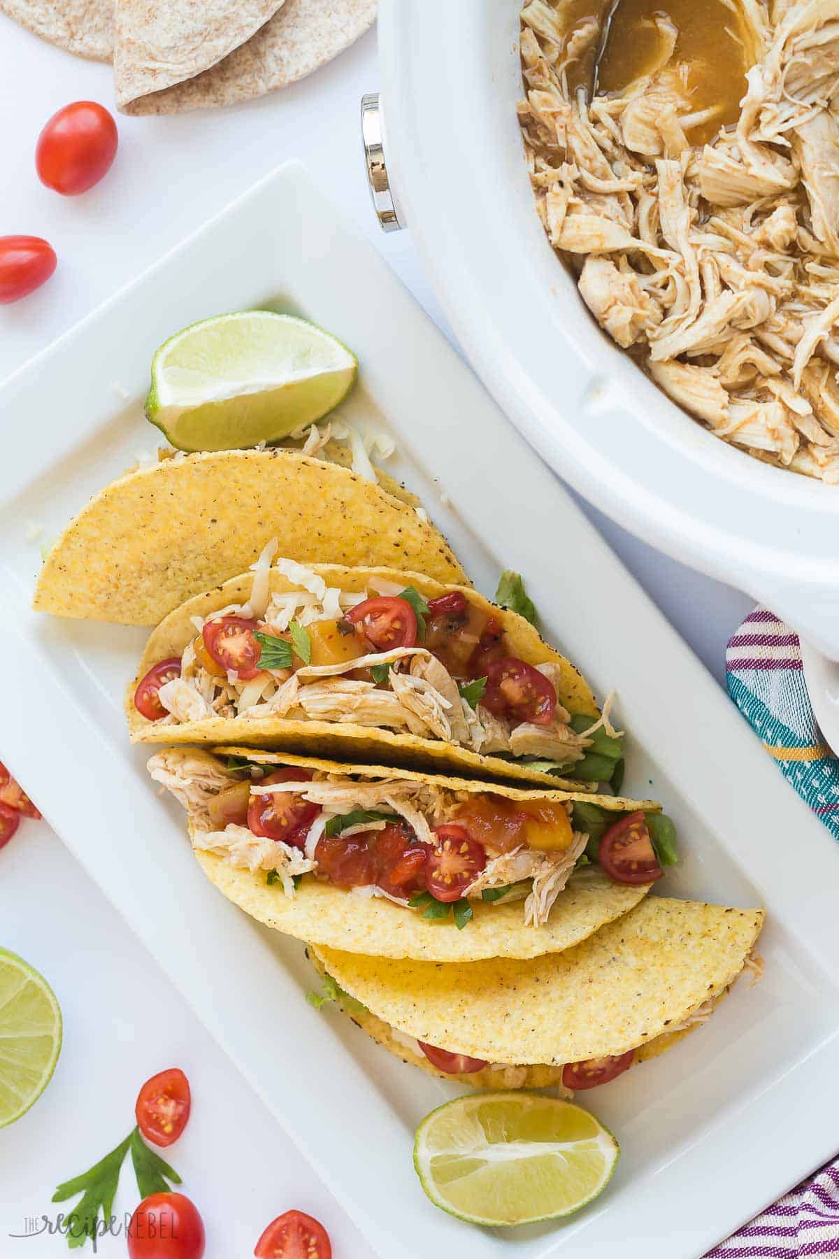 These Sweet & Spicy Slow Cooker Chicken Tacos are an easy, healthy, weeknight dinner! Just dump everything in the crockpot and forget about it. Step by step recipe video. | slow cooker recipes | crockpot recipe | crock pot recipe | chicken dinner | healthy recipe | low fat | low calorie | protein | game day | superbowl | #gameday #chickenrecipes #slowcookerrecipes