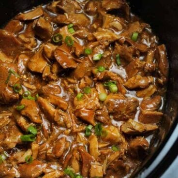 black crockpot full of bourbon chicken