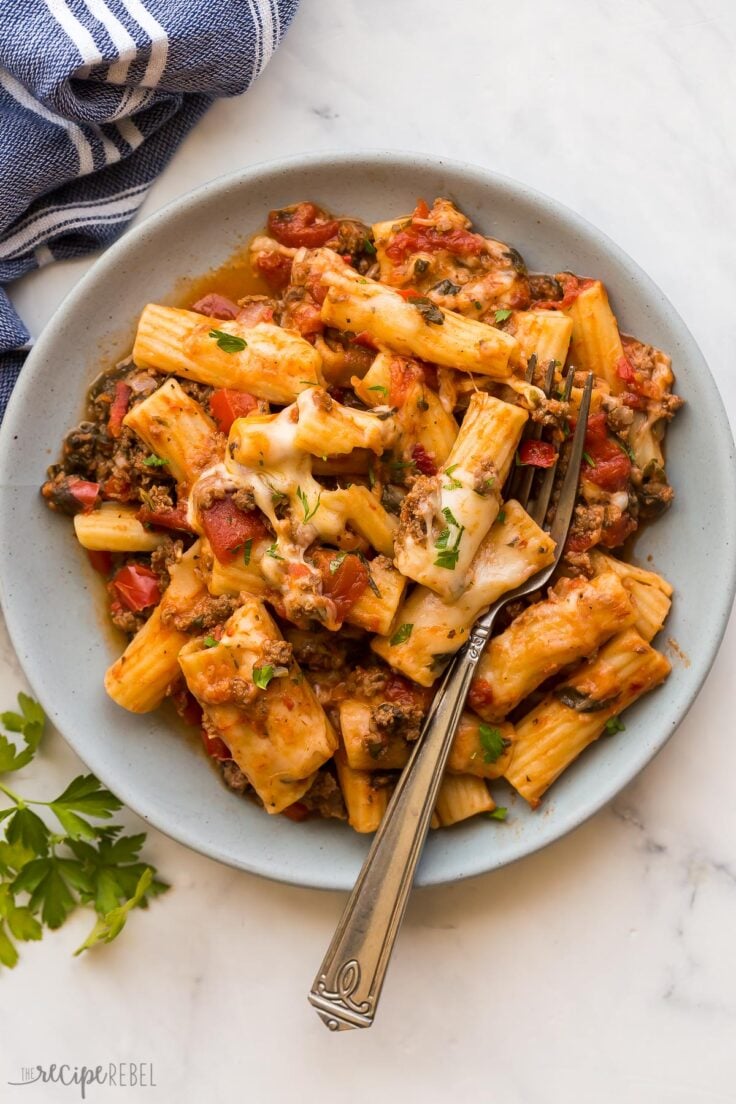 overhead image of baked ziti on plate with fork stuck in