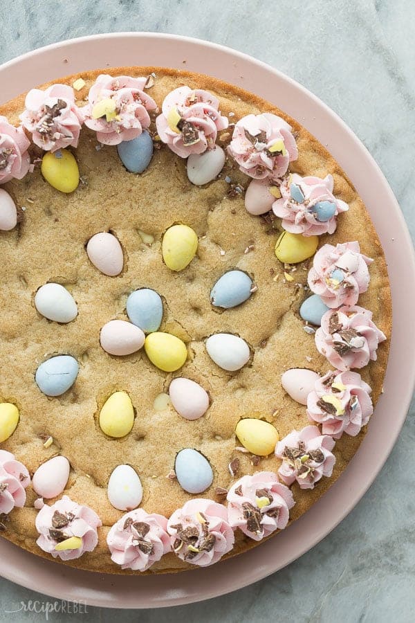easter mini egg cookie cake whole on plate overhead with pink frosting swirls