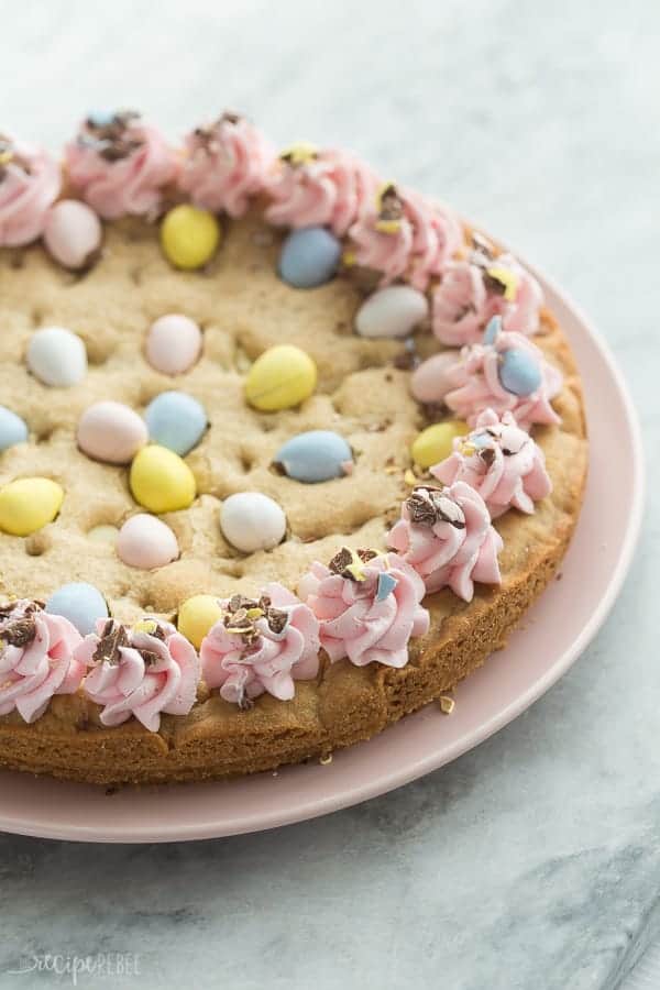 easter mini egg cookie cake whole on pink plate with pink frosting swirls