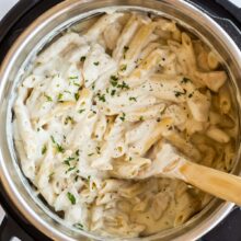 overhead image of chicken alfredo pasta in pressure cooker.