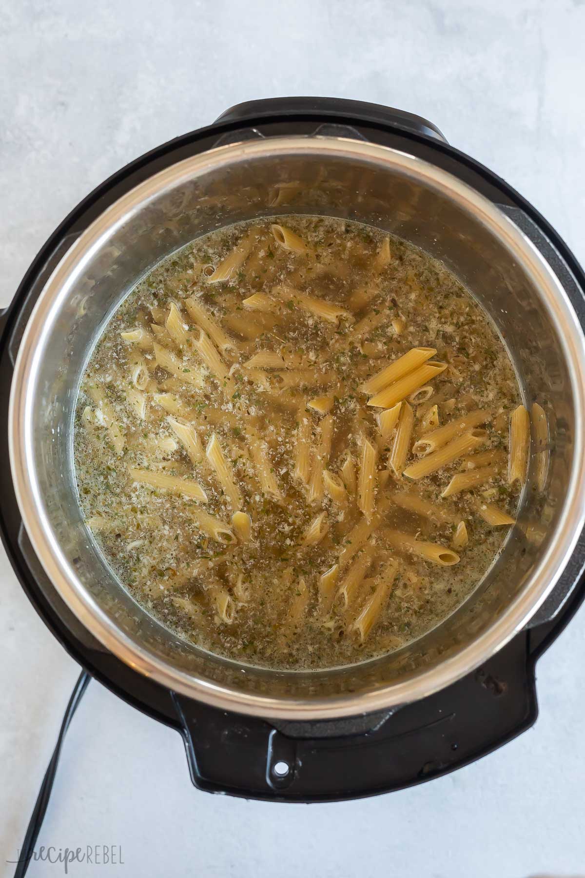 uncooked pasta added to broth in instant pot.