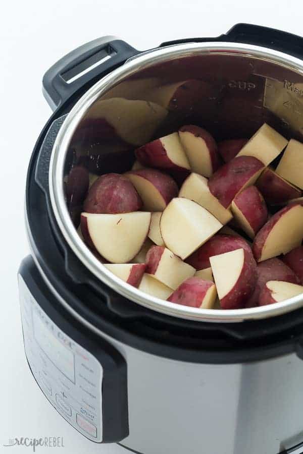 raw cubed red potatoes in instant pot on white background ready for cooking