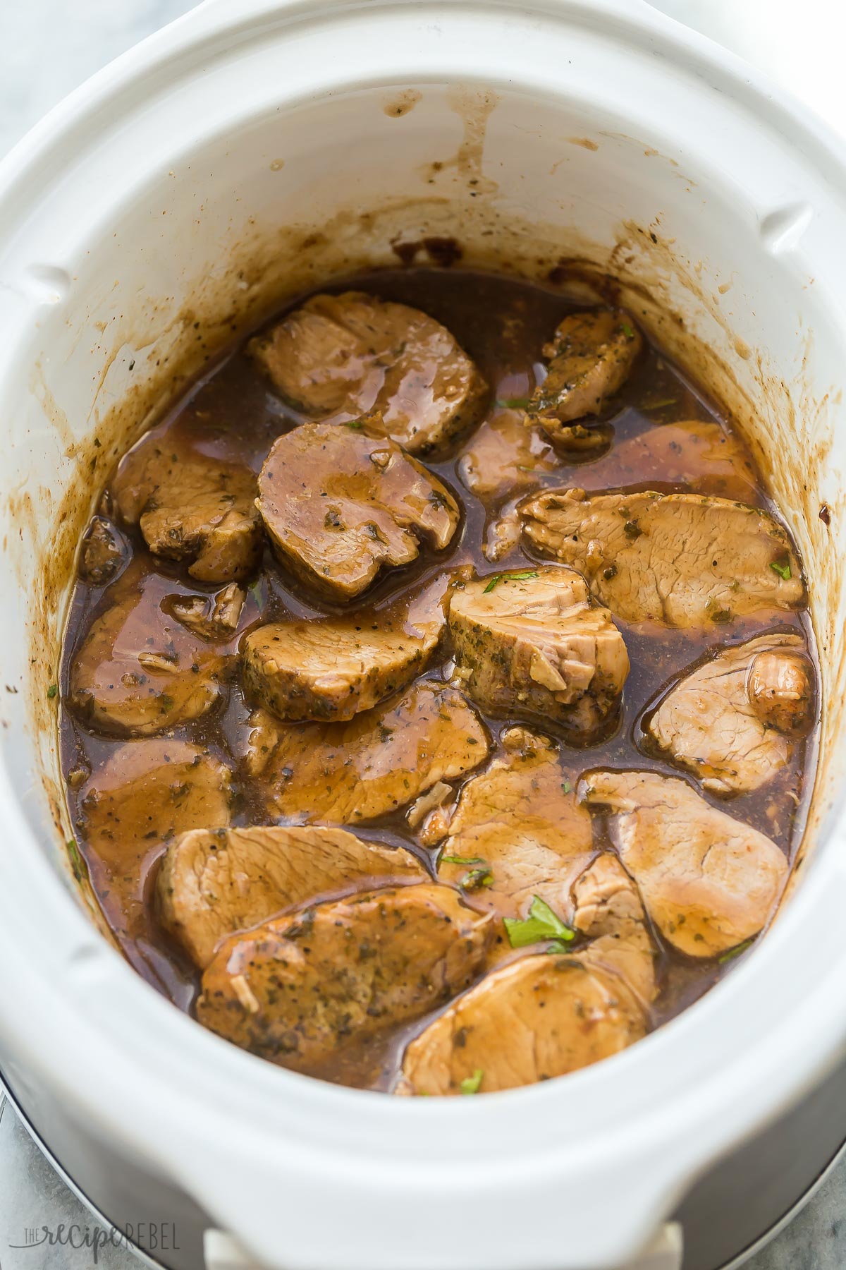 sliced pork medallions in slow cooker in sauce