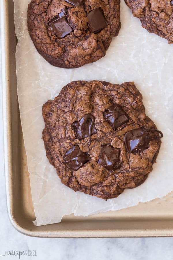 double chocolate cookies overhead on pan with melted chocolate chunks on top