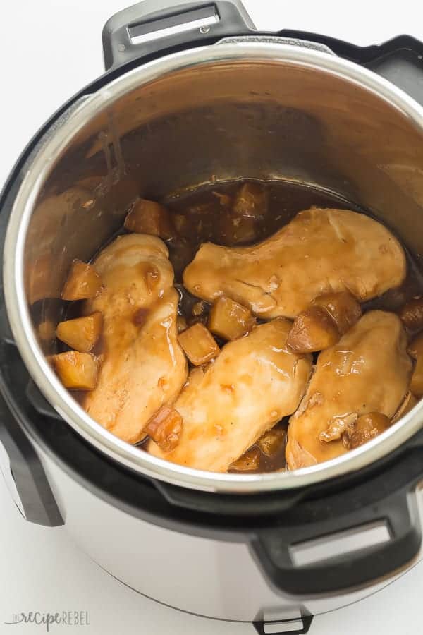 chicken breasts with pineapple sauce in instant pot on white background