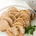 instant pot pork tenderloin on a white plate sliced