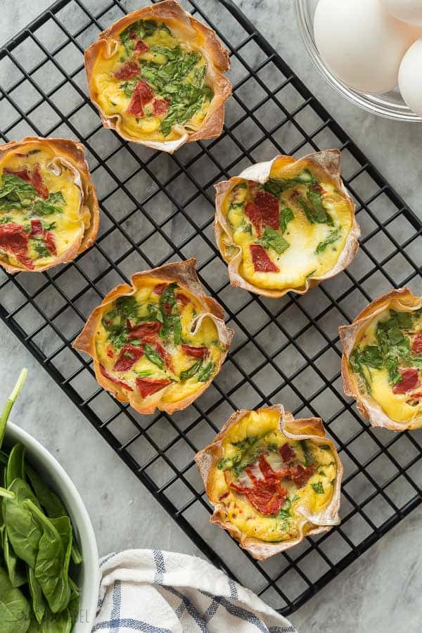 mini quiche made in wonton wrappers overhead on black cooling rack