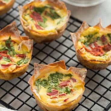 mini quiche made in wonton wrappers on black cooling rack