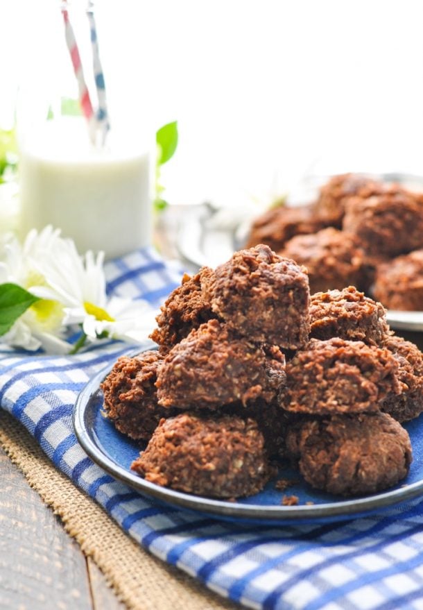 amish no bake cookies stacked on a blue plate with a blue napkin underneath